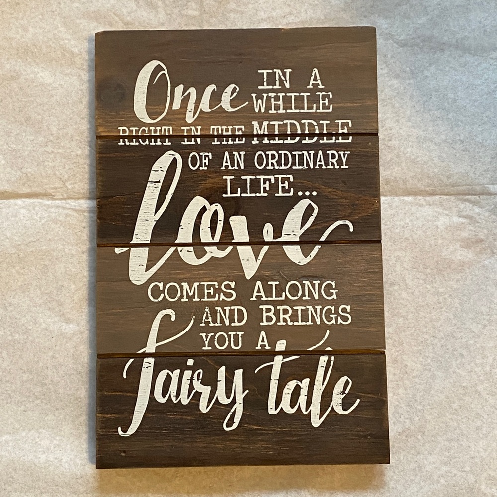 LOVE FAIRYTALE wood decor sign. Brown stained wood base with white text.